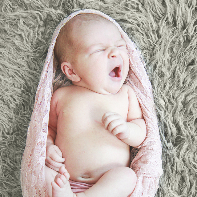 Photo of a newborn waking up.